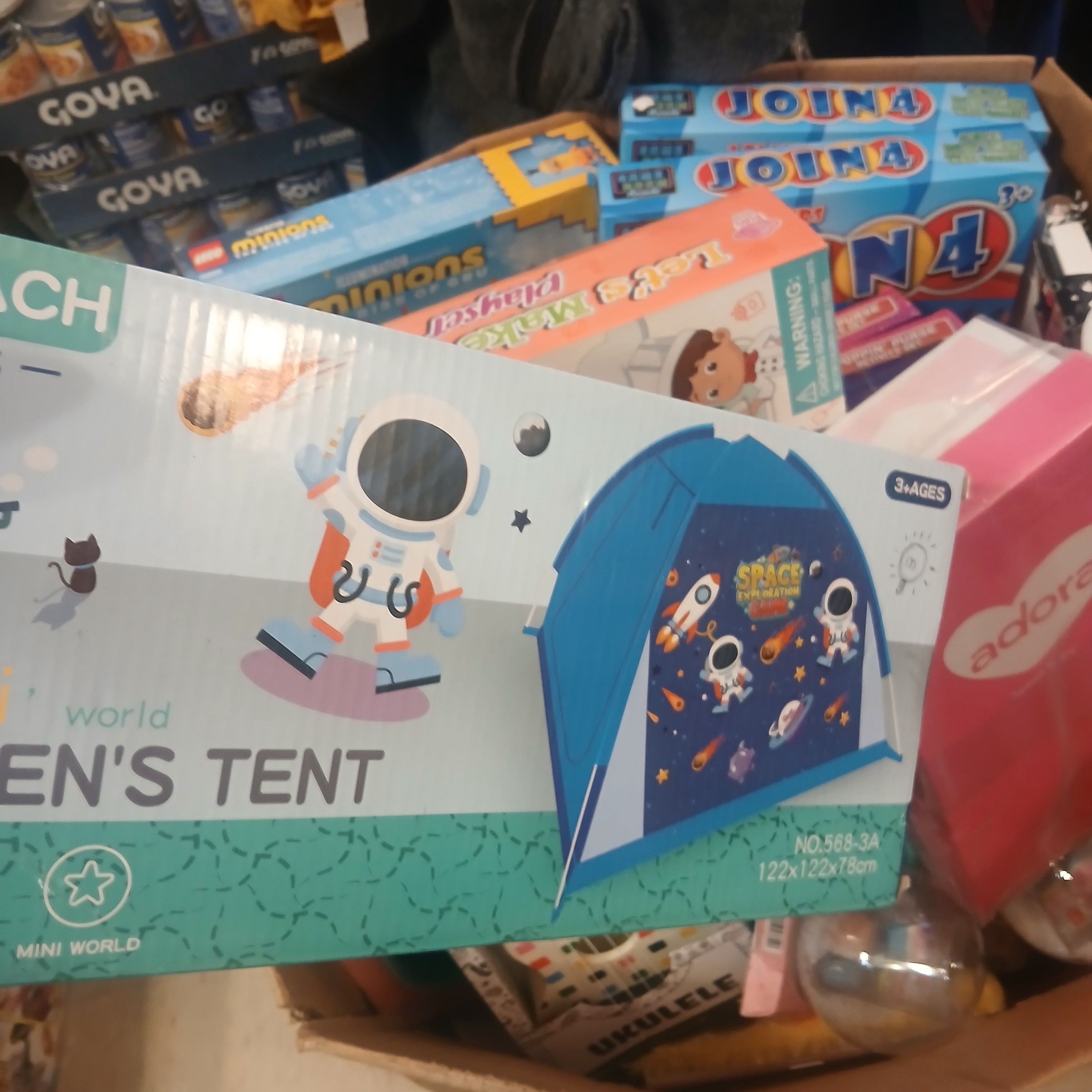 Toy boxes and children’s items arranged for a community gift event